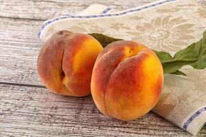 Two ripe sweet peaches fruit photo