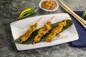 Thai meat skewer Satay with sauce photo