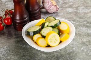 Sliced raw young green and yellow zucchini photo