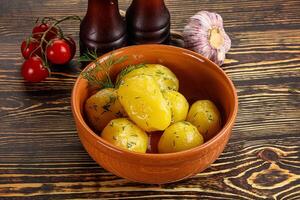 Boiled potato with oil and dill photo