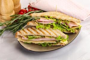 Homemade club sandwich with ham and cheese photo