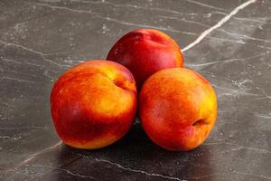 Ripe sweet juicy fresh red nectarines photo