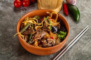 Asian wok with noodle, vegetables and beef photo