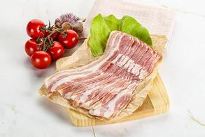 Sliced pork bacon oved board photo