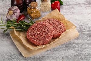 Raw burger cutlet for grill photo