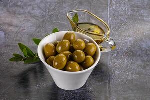 Ripe tasty green olives with branch photo