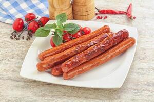 Roasted sausages in the plate photo