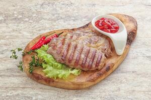 Grilled pork neck steak with ketchup photo