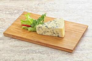 Blue cheese piece over board photo