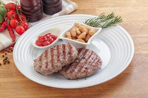 Grilled beef burger cutlet with sauce photo