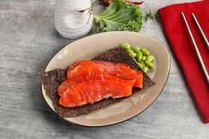 Sliced salmon sashimi in the plate photo