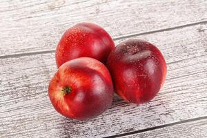 Ripe sweet juicy nectarines heap photo