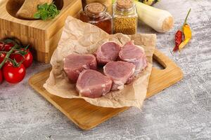 Uncooked raw pork tenderloin medallions photo