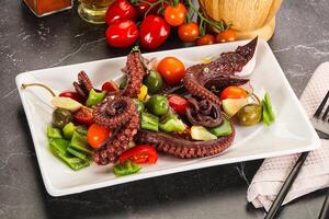 Salad with octopus tentacle and vegetables photo