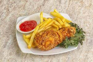 Crispy chicken leg with fry potato photo