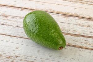 Ripe green avocado over background photo