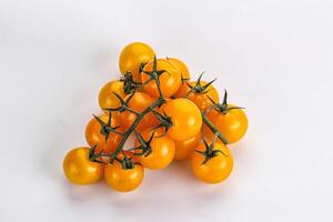 Ripe yellow cherry tomato branch photo