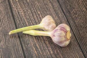 Two Young garlic over background photo