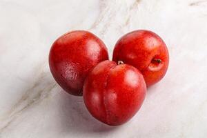 Ripe sweet juicy red plum photo