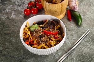 Asian wok with noodle, vegetables and beef photo