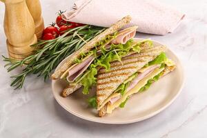 Homemade club sandwich with ham and cheese photo