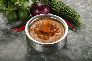 Indian cuisine - chicken curry with spices photo