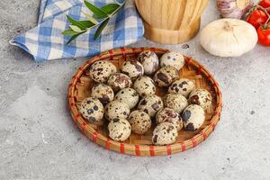 Raw quail eggs in the bowl photo