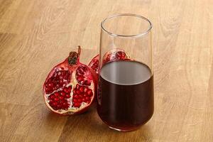 Sweet pomegranate juice in glass photo