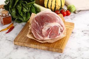 Uncooked raw pork knuckle with spices photo