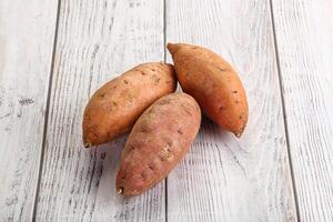 Raw ripe sweet potato heap photo