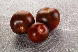 Organic natural juicy Kumato tomato photo