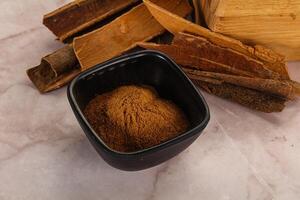 Natural Cinnamon powder with sticks photo