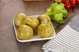 Homemade pickled green tomato appetizer photo