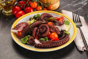 Salad with octopus tentacle and vegetables photo