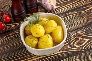 Boiled potato with oil and dill photo