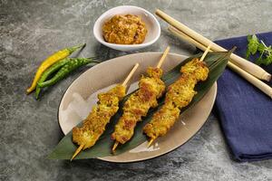 Thai meat skewer Satay with sauce photo