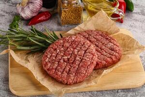 Raw burger cutlet for grill photo