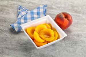 Ripe sweet and juicy canned peach photo