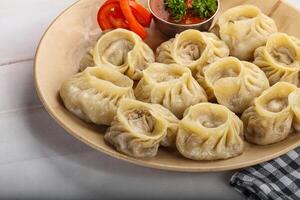 Steamed Nepali dumpling Momo with sauce photo