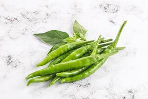 Spicy green chili pepper heap photo