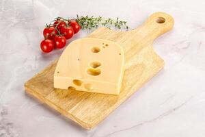 Maasdam cheese brick over board photo