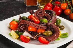 Salad with octopus tentacle and vegetables photo