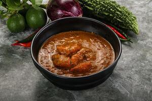 Indian cuisine - chicken curry with spices photo