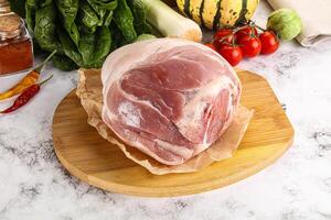 Uncooked raw pork knuckle with spices photo