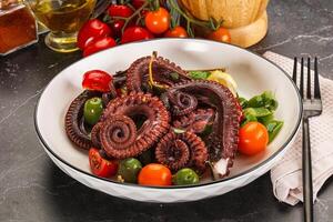 Salad with octopus tentacle and vegetables photo