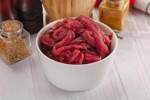 Raw beef meat - sliced strips photo