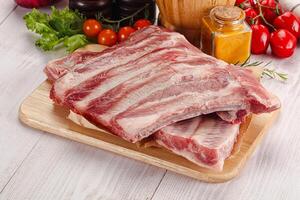 Raw pork ribs over board photo