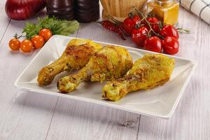 Roasted Chicken leg drumsticks with curry sauce photo