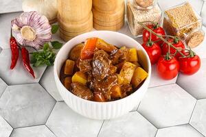 Homemade beef hungarian goulash with potato photo