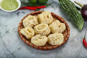 Nepali steamed dumplings  Momo with sause photo